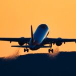 rear-view-silhouette-of-an-airplane-taking-off-at-royalty-free-image-1695239529