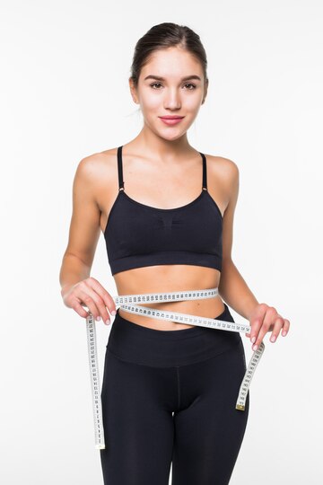 young fitness woman measure with tape her belly isolated white wall 231208 1702