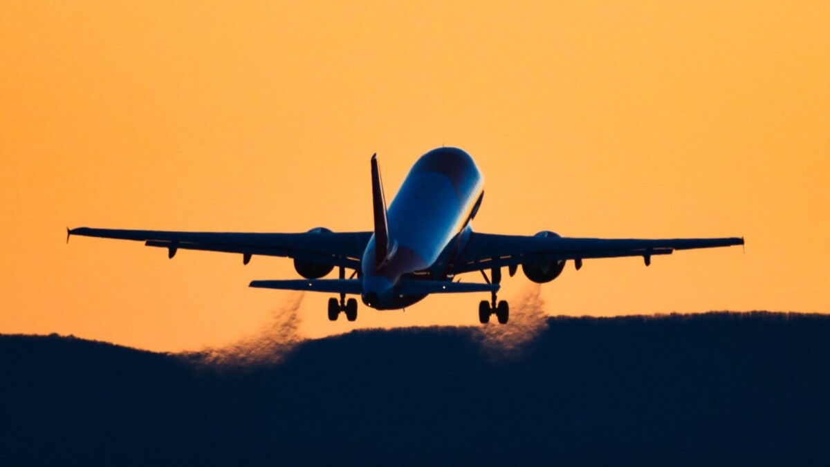 rear-view-silhouette-of-an-airplane-taking-off-at-royalty-free-image-1695239529